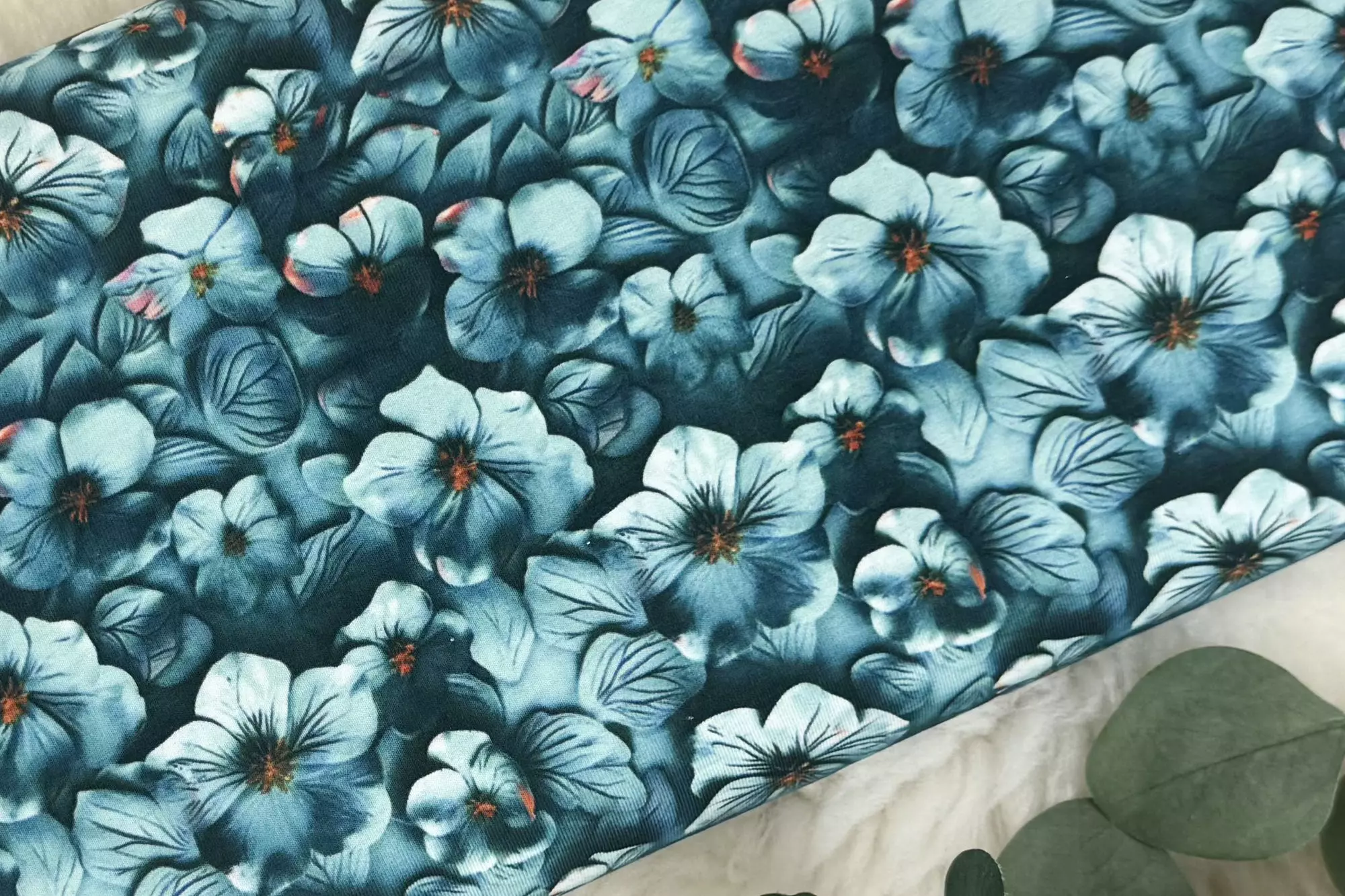 Jersey Stoff mit Blumenmuster in dunkelpetrol